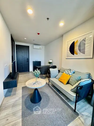 Modern living room with stylish decor and cozy seating area, perfect for relaxation.