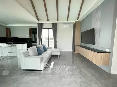 Spacious modern living room with sleek design and open kitchen layout
