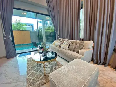 Luxurious living room with pool view and elegant decor