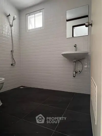 Modern minimalist bathroom with sleek fixtures and tiled walls, perfect for contemporary living.
