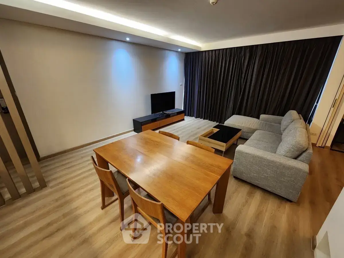 Spacious modern living room with wooden flooring and elegant furniture