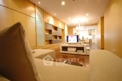 Spacious modern living room with open kitchen and elegant lighting