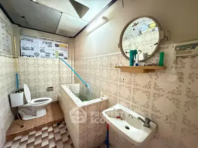 Charming vintage bathroom with unique tile design and classic fixtures, perfect for renovation enthusiasts.
