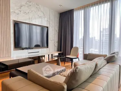 Luxurious modern living room with large TV and elegant furniture