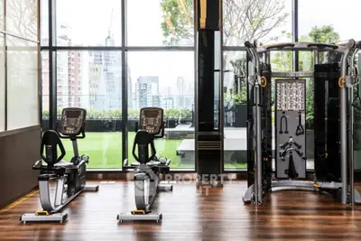 Modern gym with city view in luxury apartment building