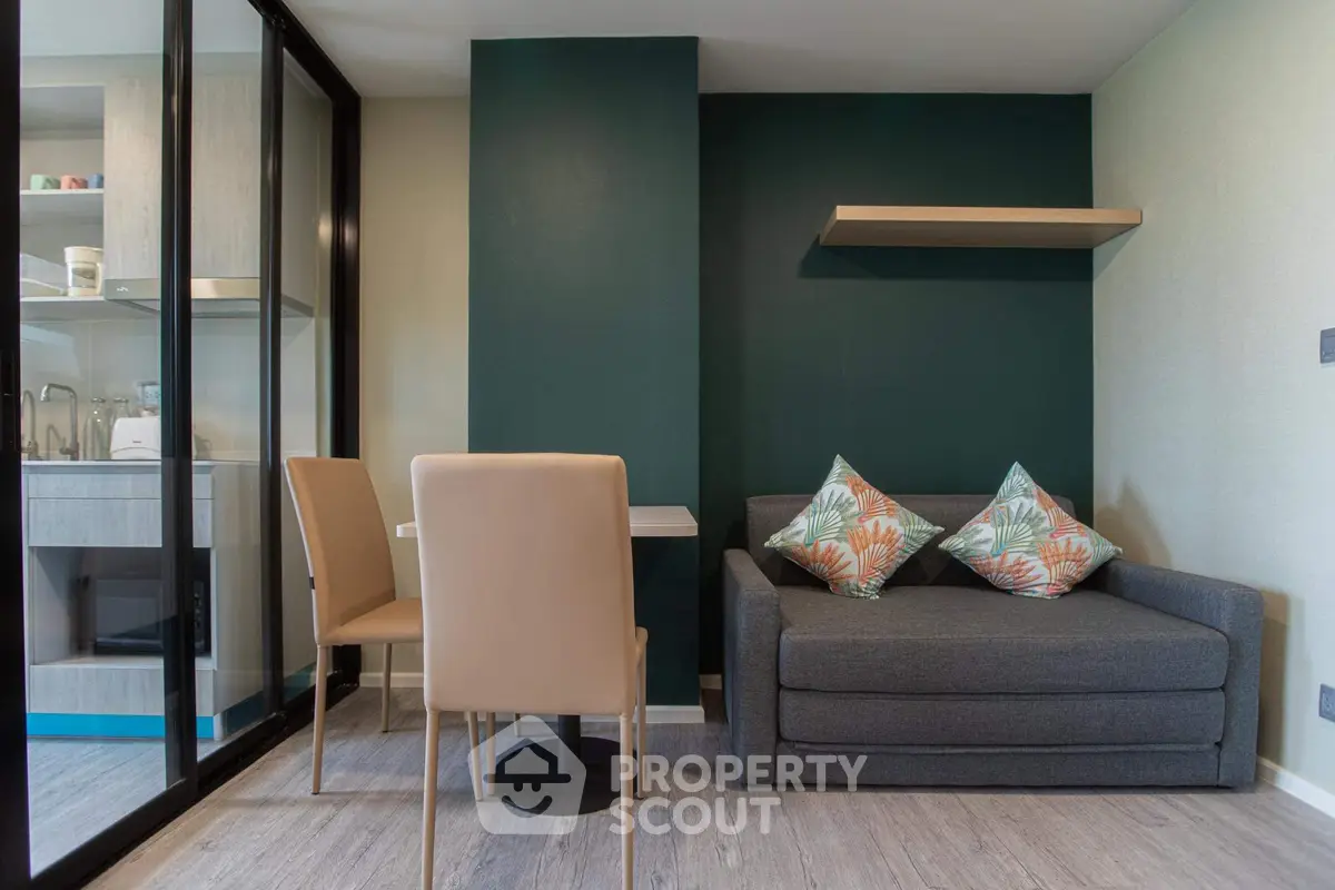 Modern living room with stylish sofa and dining area in open layout apartment.