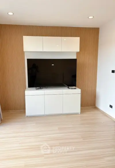Modern living room with sleek TV unit and wooden accent wall
