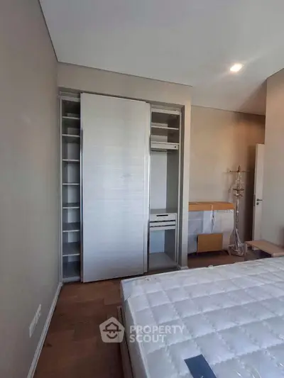 Modern bedroom with built-in wardrobe and natural light
