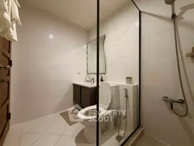 Modern bathroom with glass shower and elegant fixtures in a stylish real estate property.