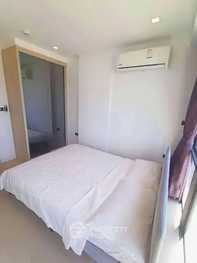 Cozy bedroom with air conditioning and natural light