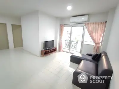 Spacious living room with modern sofa and balcony access