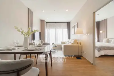 Modern open-plan living room with dining area and natural light