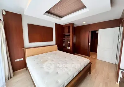 Spacious bedroom with modern wooden accents and natural light