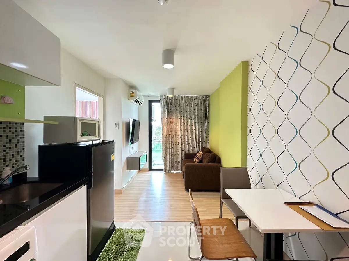 Modern open-plan living room with stylish decor and balcony access