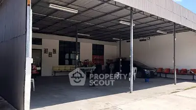 Spacious covered parking area with ample seating and vehicle storage.