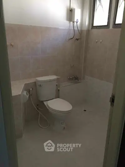 Spacious bathroom with modern fixtures and natural light.