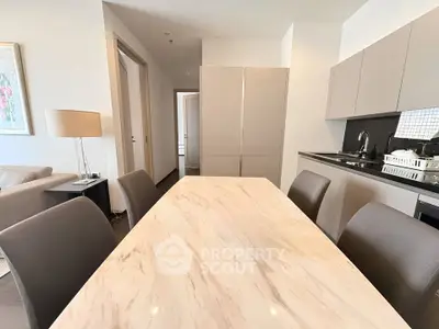 Modern open-layout kitchen and dining area with sleek design and neutral tones.