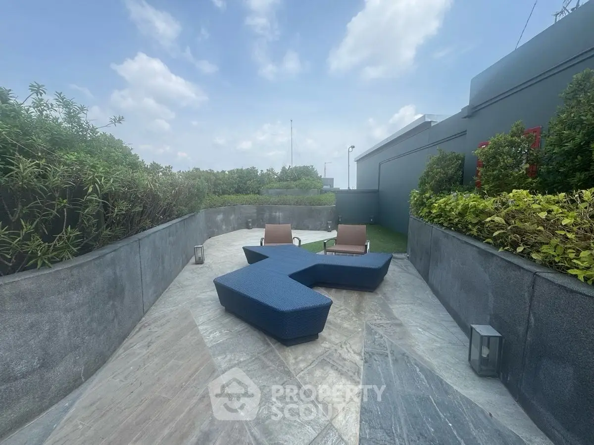 Luxurious rooftop terrace with modern seating and lush greenery