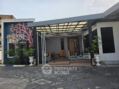 Modern house exterior with artistic wall mural and spacious patio