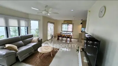 Spacious living room with modern decor and large windows offering natural light.