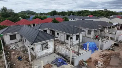 Aerial view of new residential development with modern houses under construction.