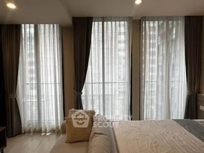 Luxurious bedroom with floor-to-ceiling windows and elegant curtains