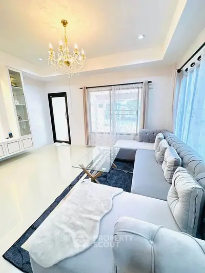 Luxurious living room with elegant chandelier and plush sectional sofa