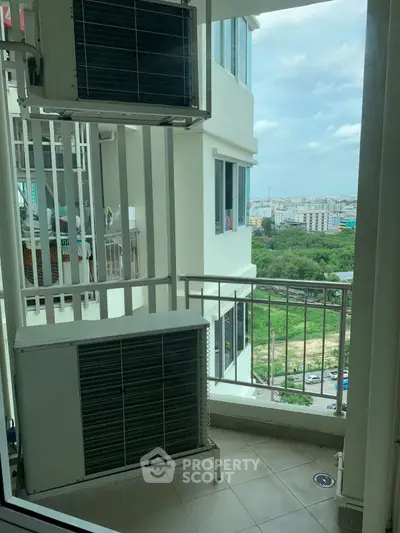 High-rise apartment balcony with city view and air conditioning units