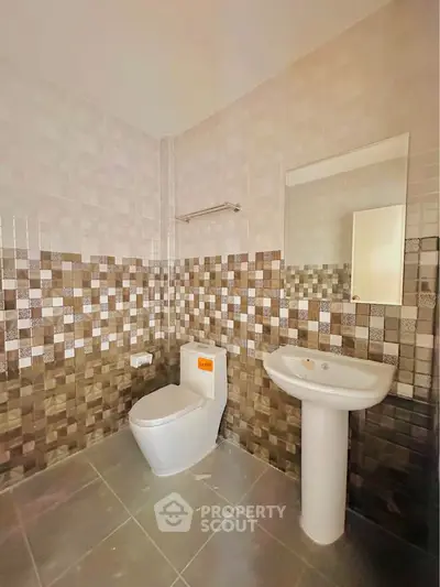 Modern bathroom with stylish tile design and pedestal sink