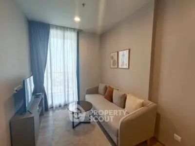 Cozy living room with modern sofa and natural light from large window