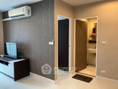 Modern apartment interior with TV unit and bathroom entrance