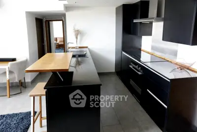 Modern kitchen with sleek black cabinets and open layout design