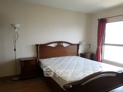 Spacious bedroom with elegant wooden furniture and natural light