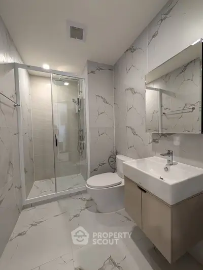 Modern bathroom with sleek shower and elegant marble tiles