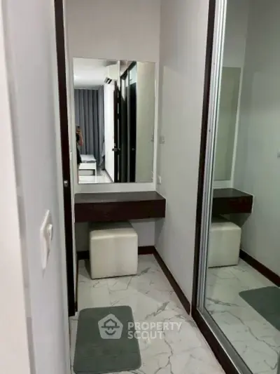 Modern bedroom with sleek vanity and mirrored closet doors