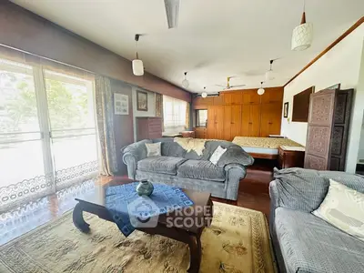 Spacious living room with cozy sofas and large windows for natural light.