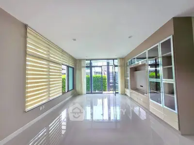 Spacious modern living room with large windows and sleek design