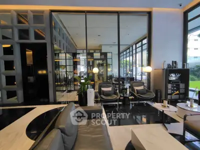 Luxurious modern living room with sleek furniture and floor-to-ceiling windows offering a stunning view.