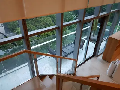 Luxurious modern home with stunning balcony view and floor-to-ceiling windows