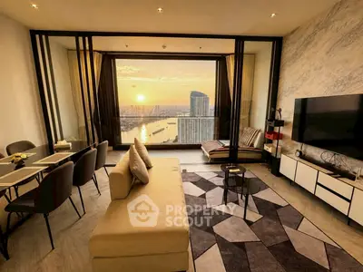 Luxurious living room with stunning sunset river view, modern decor, and spacious layout.