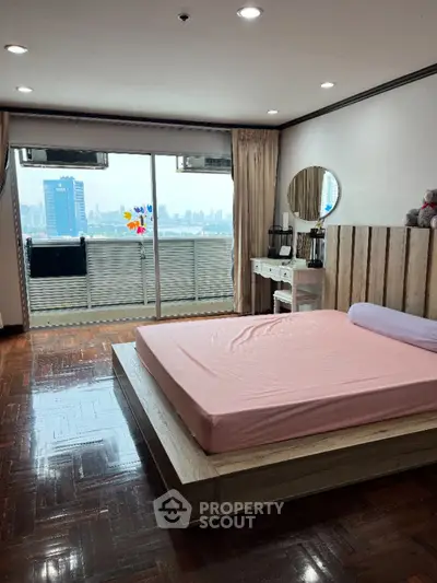 Spacious bedroom with city view and large balcony access