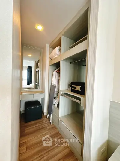 Spacious walk-in closet with modern design and ample storage space in a luxury apartment.