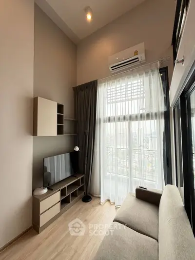 Modern living room with high ceiling and large windows offering city views