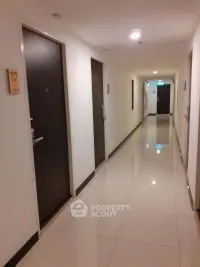 Well-maintained apartment building hallway with modern lighting and clean, polished floors, offering a welcoming path to your new home.