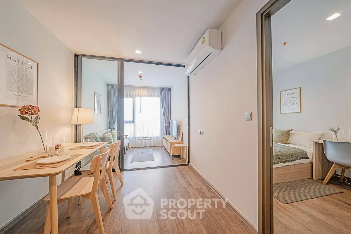 Modern apartment interior with dining area and cozy bedroom, featuring stylish decor and natural light.