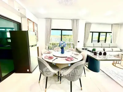 Luxurious open-plan living and dining area with elegant decor and modern furnishings.