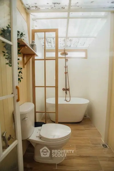 Charming bathroom with modern freestanding bathtub and wooden accents.