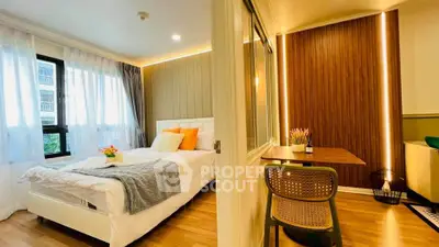 Modern bedroom with cozy study nook, featuring elegant lighting and stylish decor.