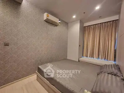 Modern bedroom with stylish wallpaper and air conditioning unit