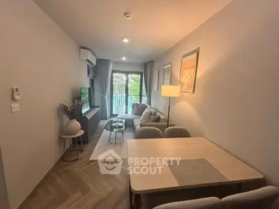 Modern living room with cozy seating and natural light, perfect for relaxation and entertainment.